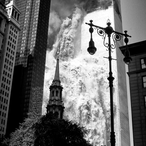 Smoke rising through Lower Manhattan behind a church spire, 11 September 2001