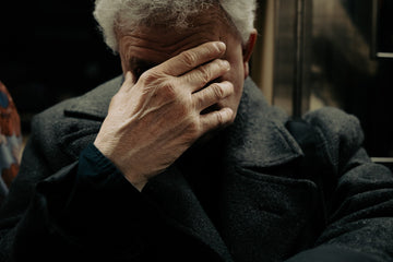 Man covering his face with hand. The weight we carry often shows in the ways we try to hide it. In a single gesture, silence speaks louder than words.