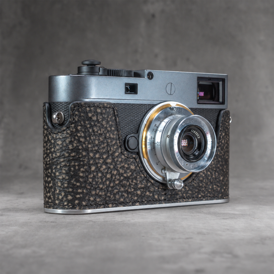 A Leica M11 in the Buffalo SlimCase with a silver lens fitted, three quarter view