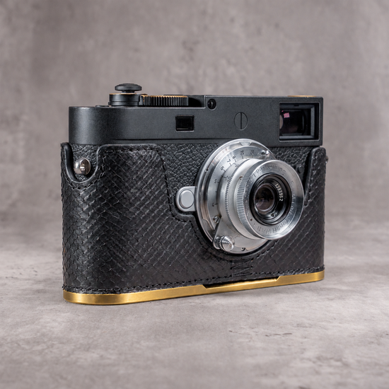 Black python FlexCase on a Leica M11 with the solid brass plate, gold edge below the leather