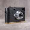 Black python FlexCase on a Leica M11 with the solid brass plate, gold edge below the leather