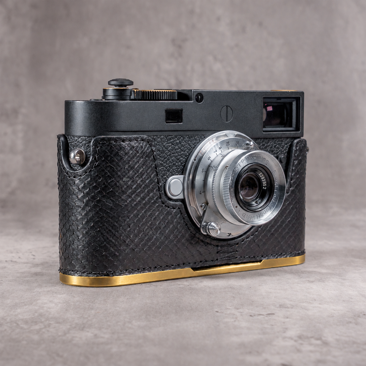 Black python FlexCase on a Leica M11 with the solid brass plate, gold edge below the leather