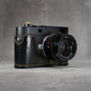 Black gloss lizard FlexCase on a Leica M11, front three-quarter view from the right