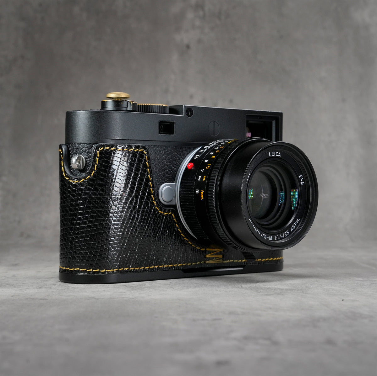 Black gloss lizard FlexCase on a Leica M11, front three-quarter view from the right