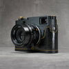Leica M11 in a black gloss lizard FlexCase, front three-quarter view from the left