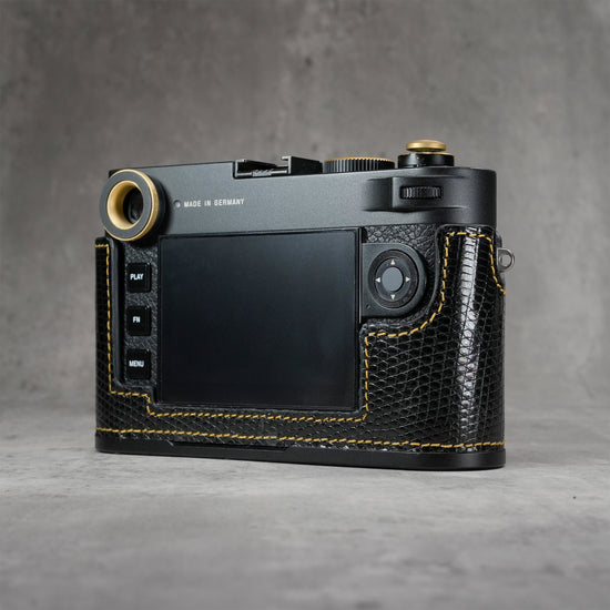 Camera in a black gloss lizard FlexCase seen from the back, screen and controls clear of the leather