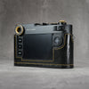 Camera in a black gloss lizard FlexCase seen from the back, screen and controls clear of the leather