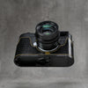 Leica M11 in a black gloss lizard FlexCase seen from below, Black Chrome base plate showing