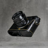 Underside of the black gloss lizard FlexCase on a Leica M11, base plate cutouts showing