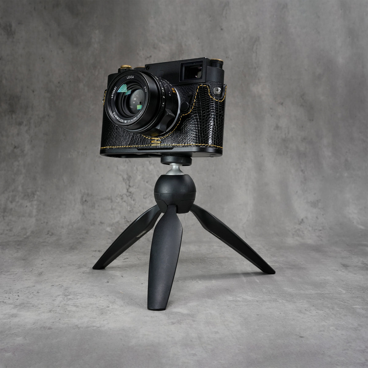 Leica M11 in a black gloss lizard FlexCase mounted on a tabletop tripod