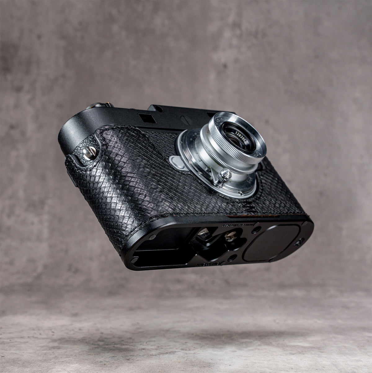 Underside of the black python FlexCase on a Leica M11, base plate and anti-skid pads showing