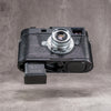 Battery released from a Leica M11 with the black python FlexCase still fitted