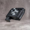 Battery released from the black python FlexCase base plate, seen from the back three-quarter