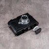 AirTag and its cover cap beside the bay machined into the black python FlexCase base plate