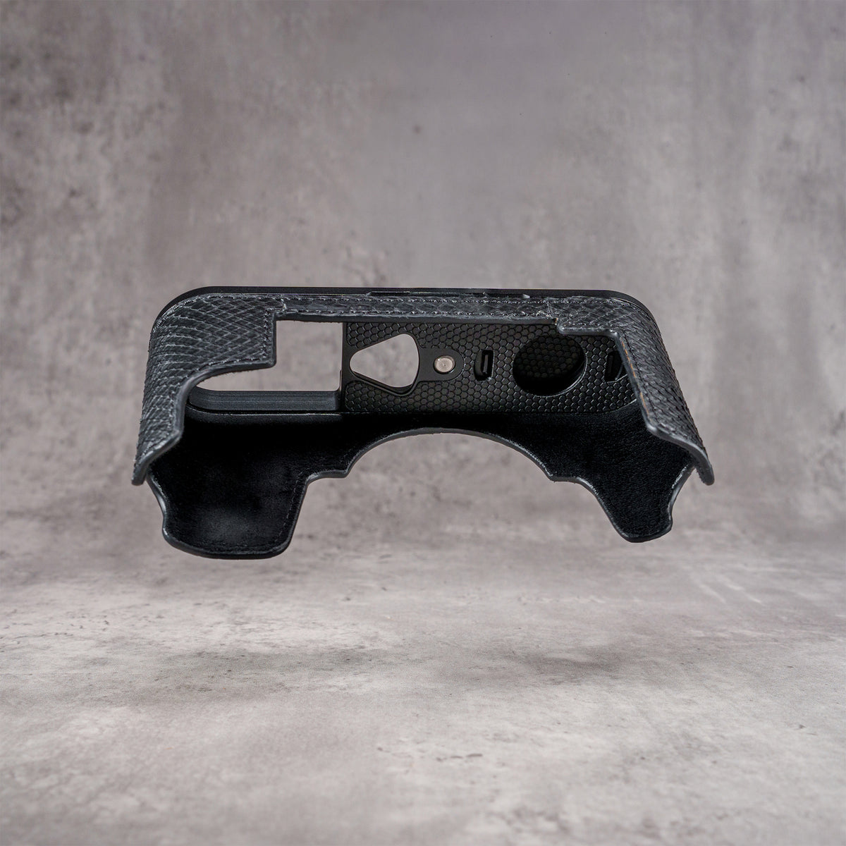Black python FlexCase seen from the inside, fully lined, with the port cutouts showing