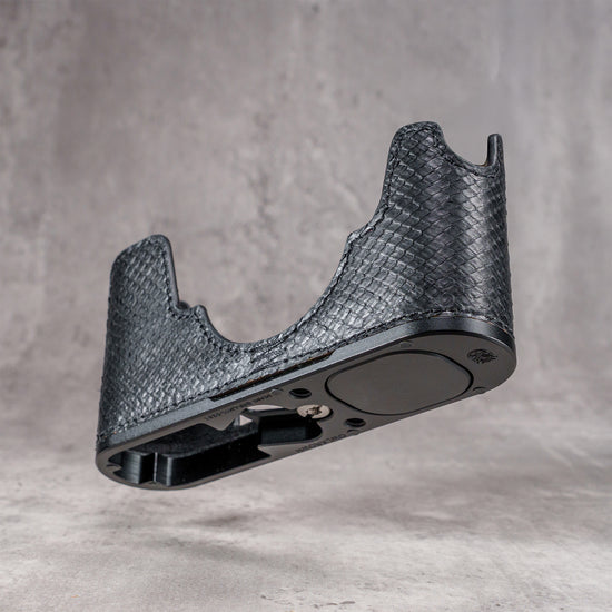 Black python FlexCase on its own, empty, showing the base plate and anti-skid pads