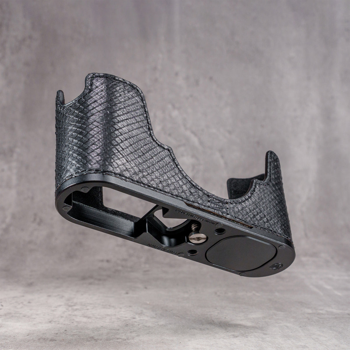 Black python FlexCase on its own, three-quarter view of the body and base plate