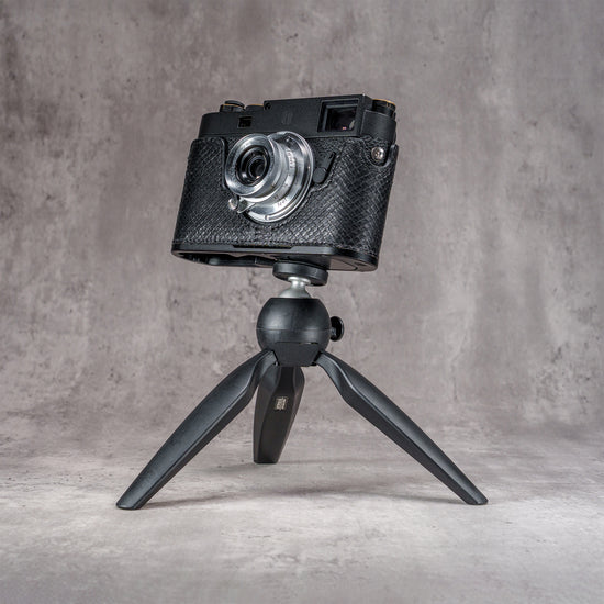 Leica M11 in a black python FlexCase mounted on a tabletop tripod