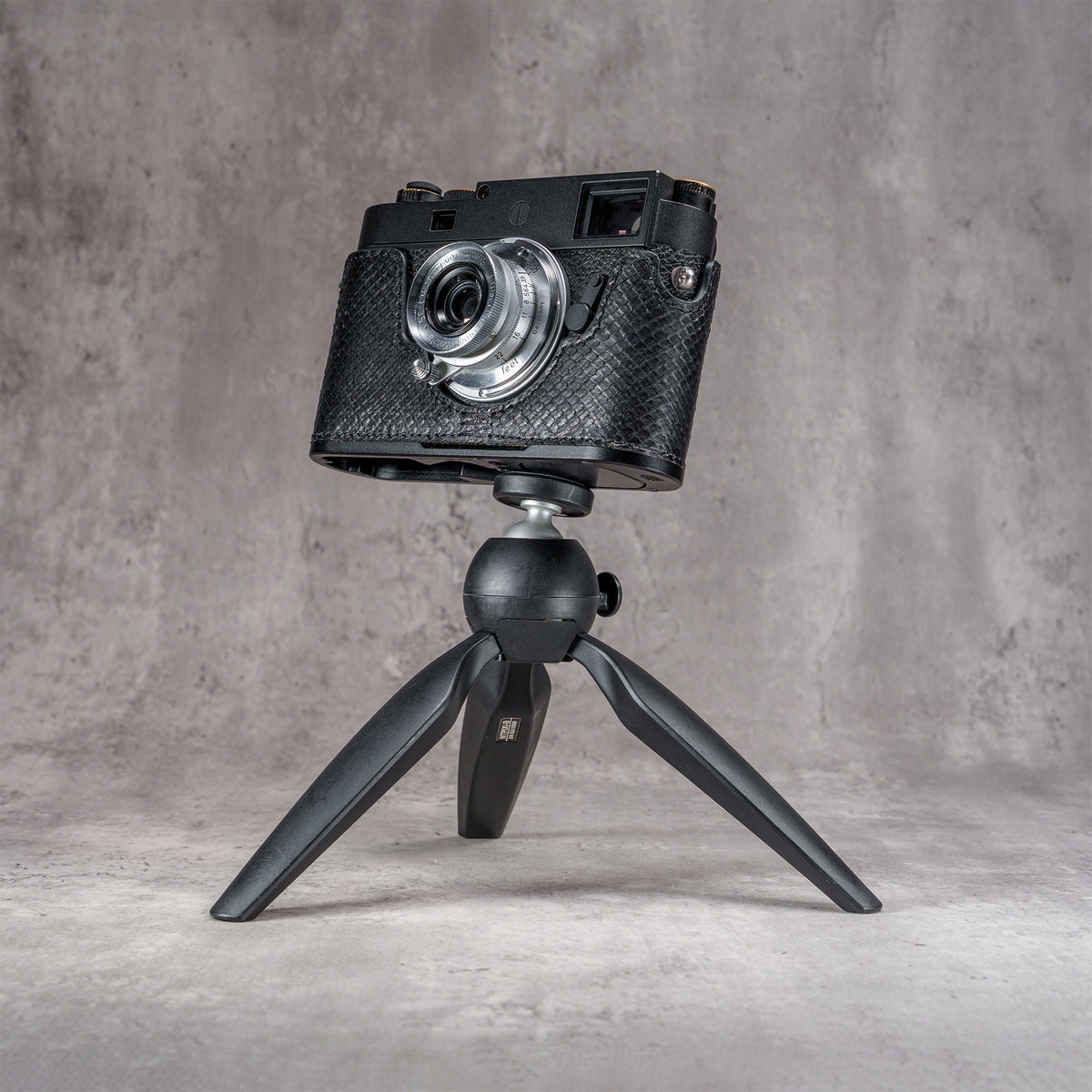 Leica M11 in a black python FlexCase mounted on a tabletop tripod