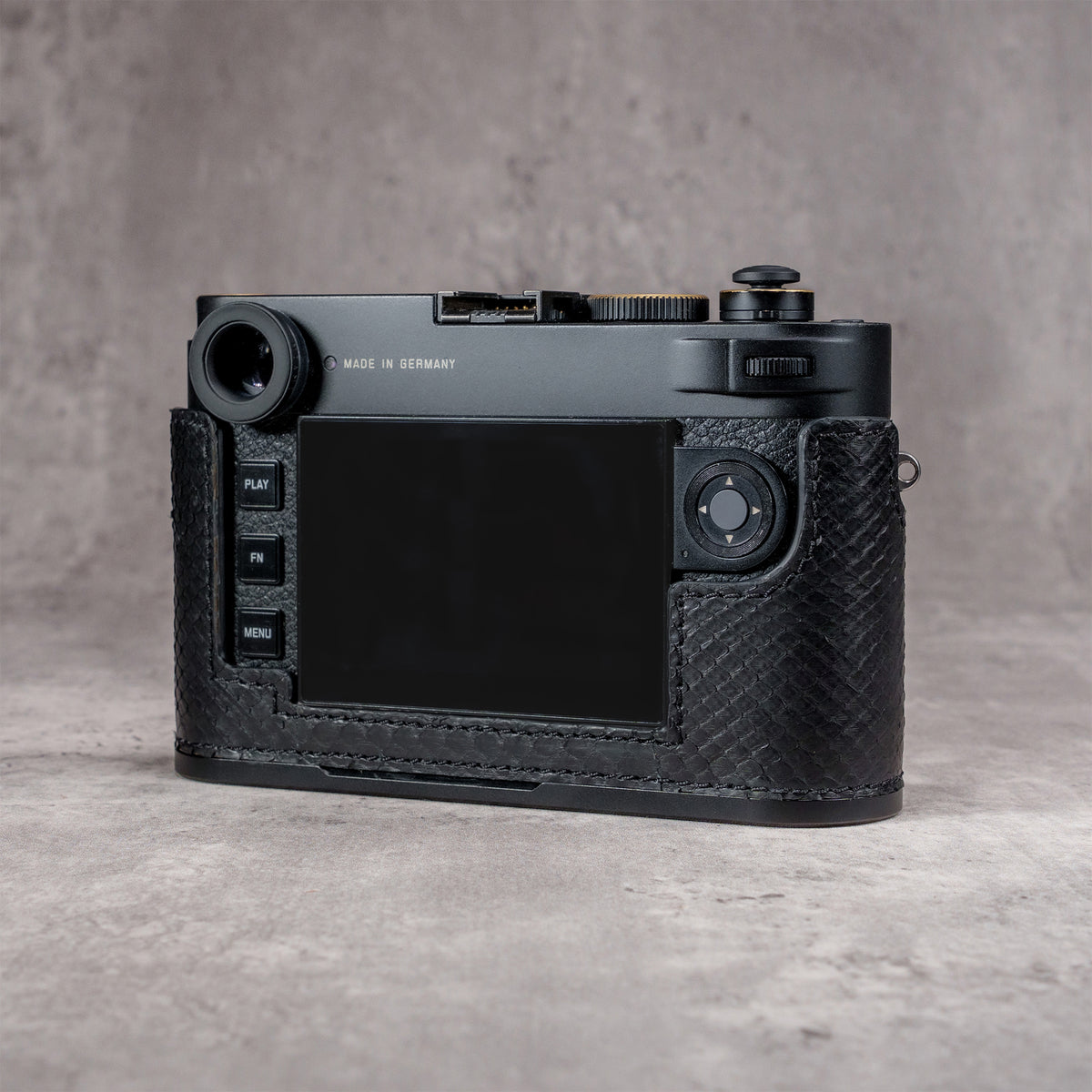Back of the camera in a black python FlexCase, screen and controls clear of the leather