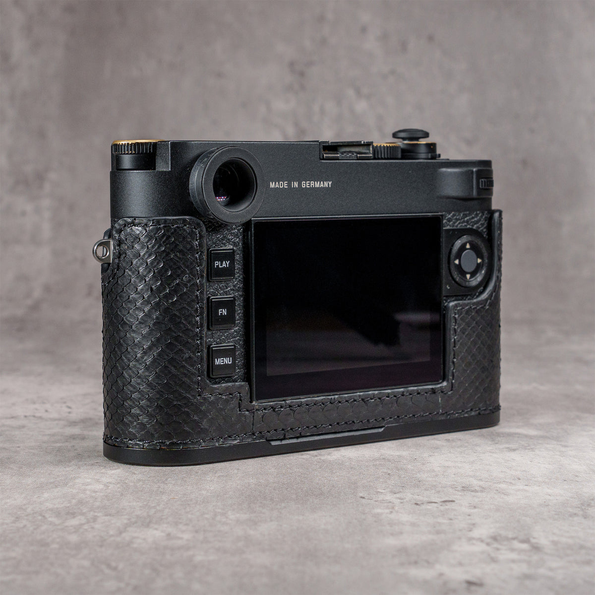 Back three-quarter view of the camera in a black python FlexCase