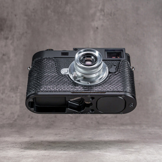 Leica M11 in a black python FlexCase seen from below, base plate cutouts showing
