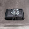 Leica M11 in a black python FlexCase seen from below, base plate cutouts showing