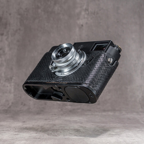 Black python FlexCase on a Leica M11, low three-quarter view of the base plate