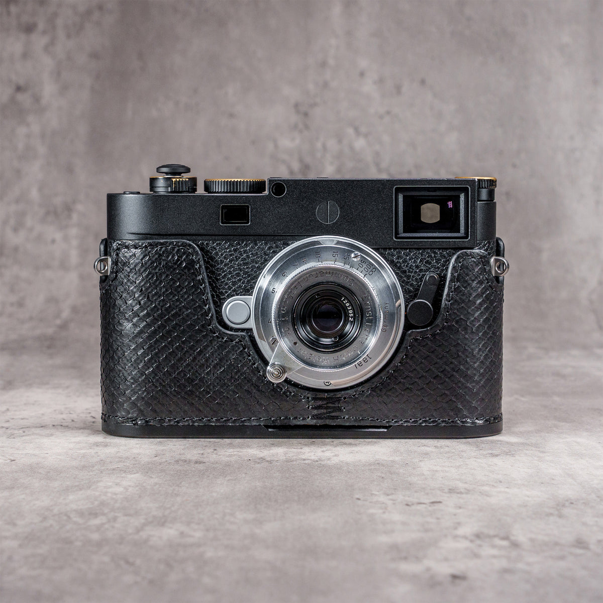 Black python FlexCase on a Leica M11, front view with the strap lug showing