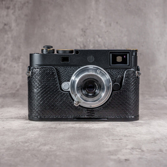 Black python FlexCase on a Leica M11, front view with the strap lug showing