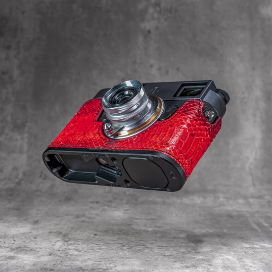 Underside of the red python FlexCase on a Leica M11, base plate cutouts showing