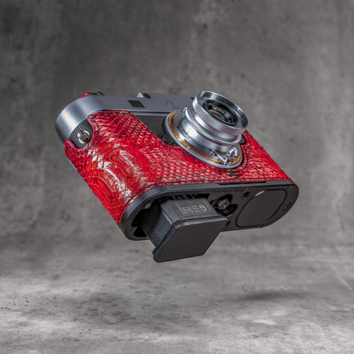Red python FlexCase on a Leica M11, three-quarter view from below with the battery out
