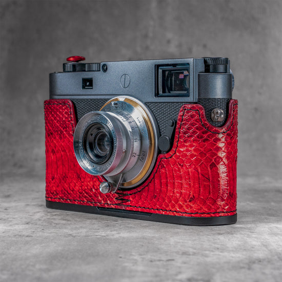 Red python FlexCase on a Leica M11, front three-quarter view from the left