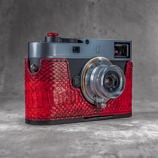 Leica M11 in a red python FlexCase, front three-quarter view with the lens forward
