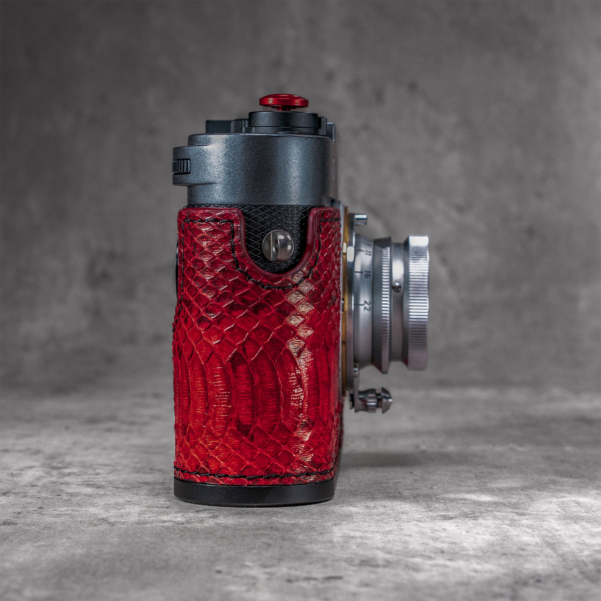 Side view of the red python FlexCase on a Leica M11, strap lug and case profile