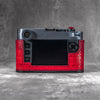 Camera in a red python FlexCase seen from the back, straight on, screen and controls clear of the leather
