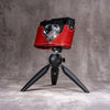 Leica M11 in the Ruby Gloss FlexCase mounted on a tabletop tripod with the case still fitted