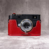 Ruby Gloss FlexCase on a Leica M11, front view showing the red pebbled leather and cream stitching