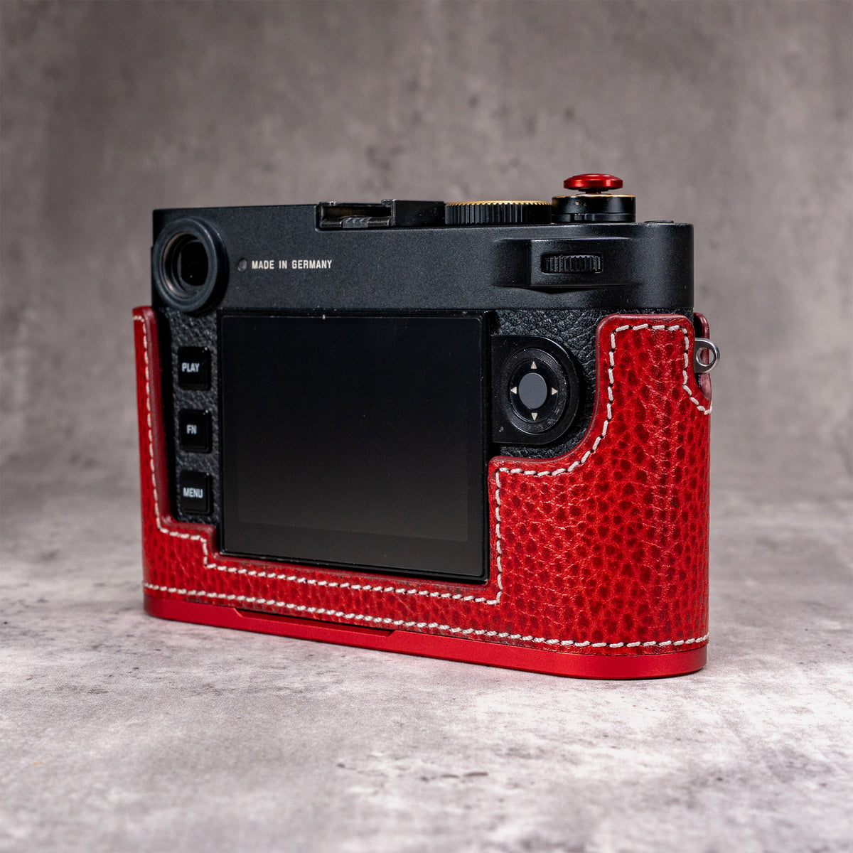 Back of a Leica M11 in the Ruby Gloss FlexCase, screen and thumb controls left clear