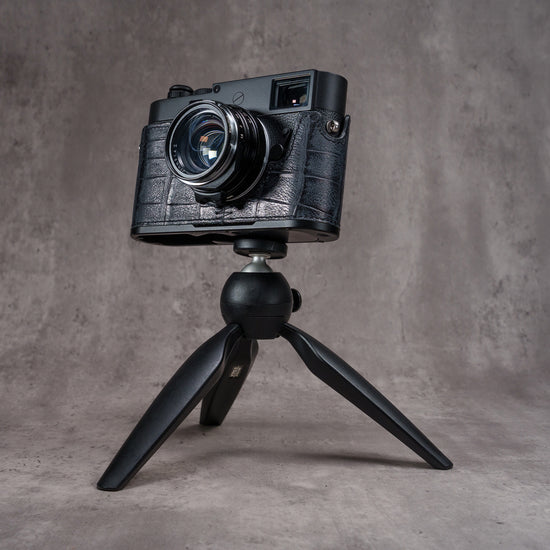 Leica M camera in the Black Swamp FlexCase mounted on a small black tabletop tripod