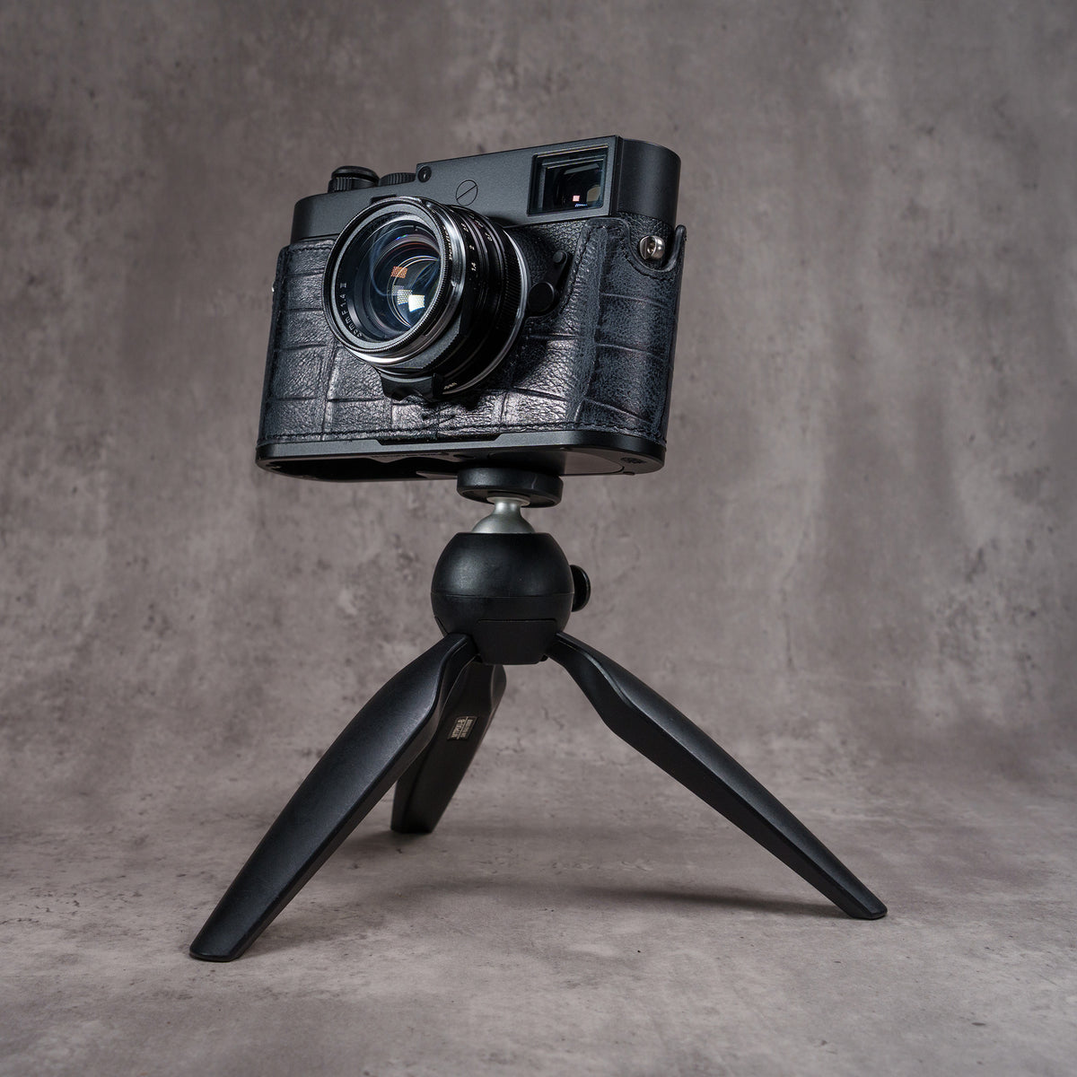 Leica M camera in the Black Swamp FlexCase mounted on a small black tabletop tripod