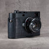Black Swamp FlexCase on a Leica M camera, front three-quarter view from the right with the lens forward