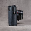 Black Swamp FlexCase, side view showing the gator pattern leather wrapping the grip and the strap lug