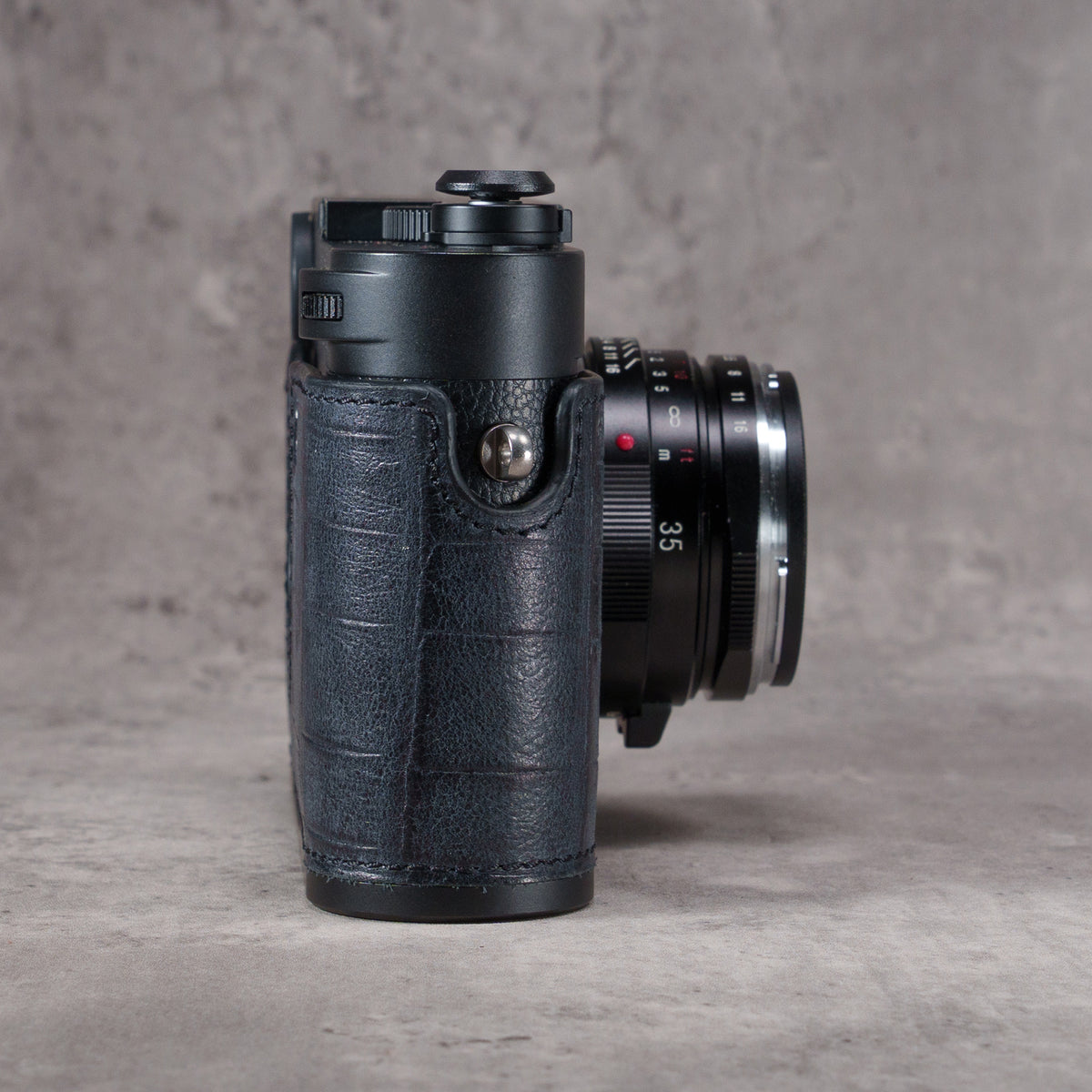 Black Swamp FlexCase, side view showing the gator pattern leather wrapping the grip and the strap lug