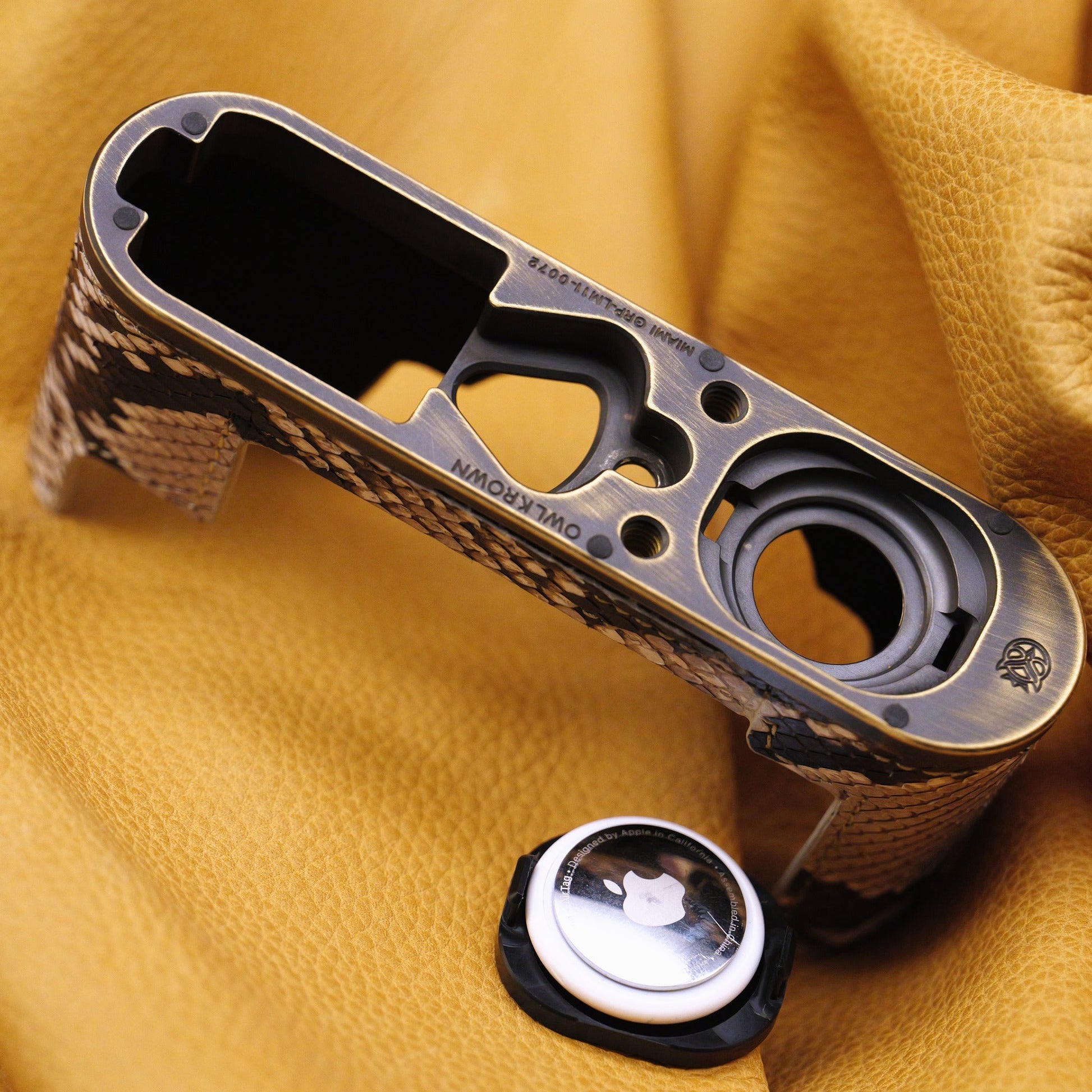 Python FlexCase brass plate with an AirTag beside its compartment