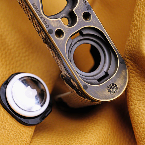 AirTag and the Owlkrown-engraved brass plate of the Python FlexCase