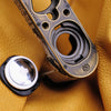 AirTag and the Owlkrown-engraved brass plate of the Python FlexCase