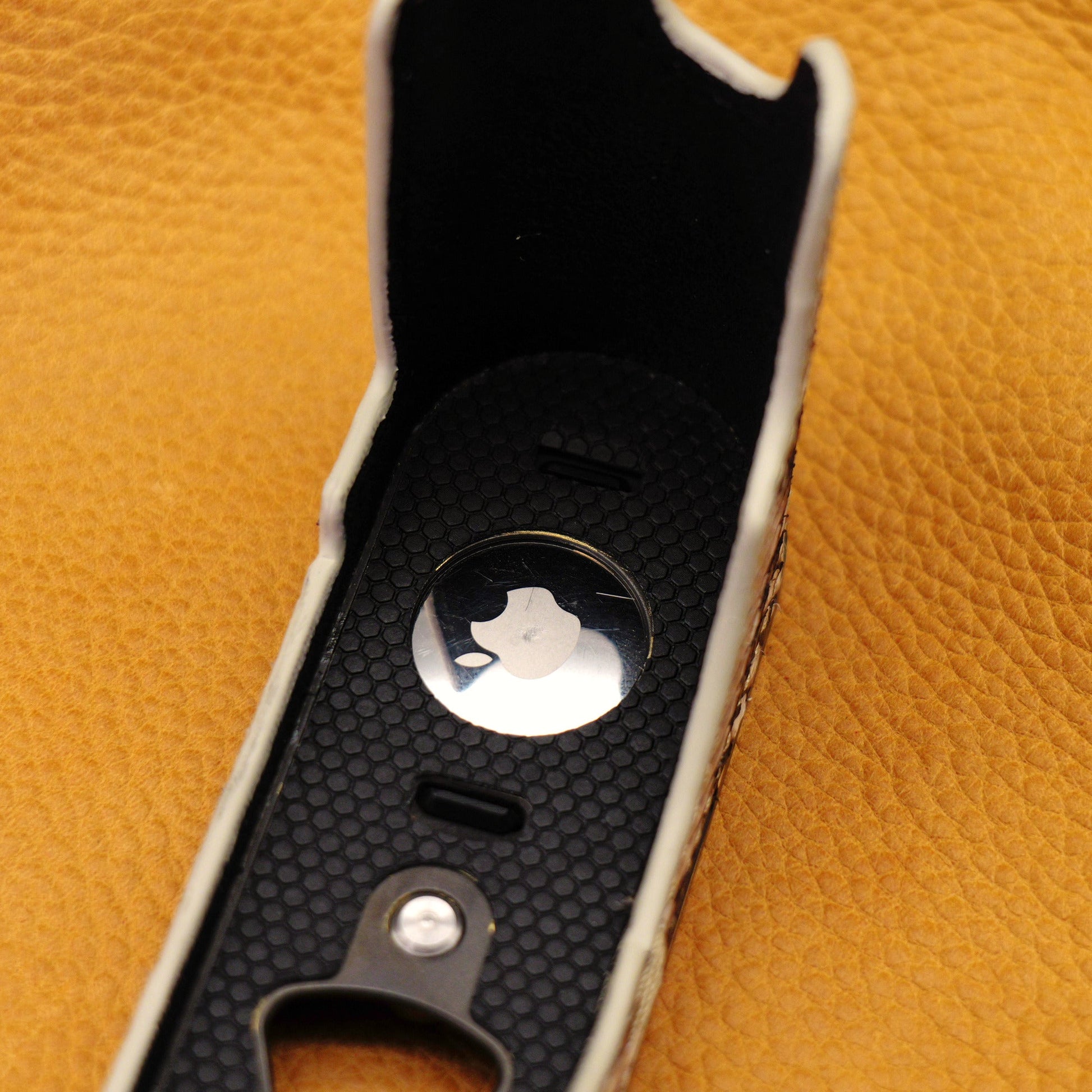 AirTag seated in the brass plate compartment of the Python FlexCase