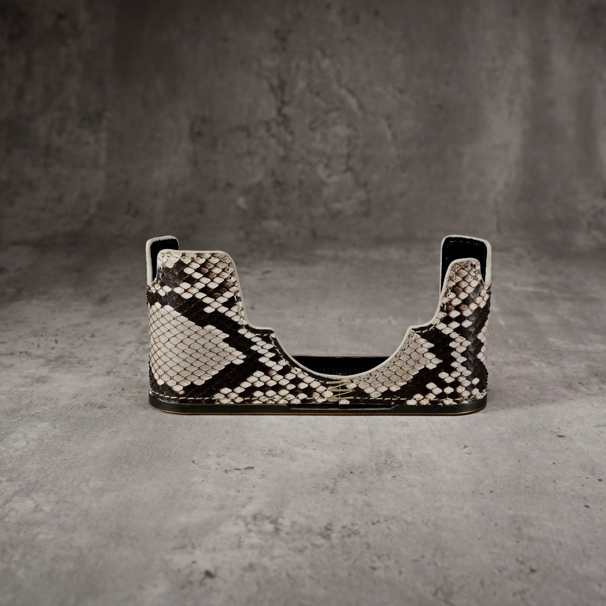 Python FlexCase for the Leica M11 seen from the front, empty, on a grey studio backdrop