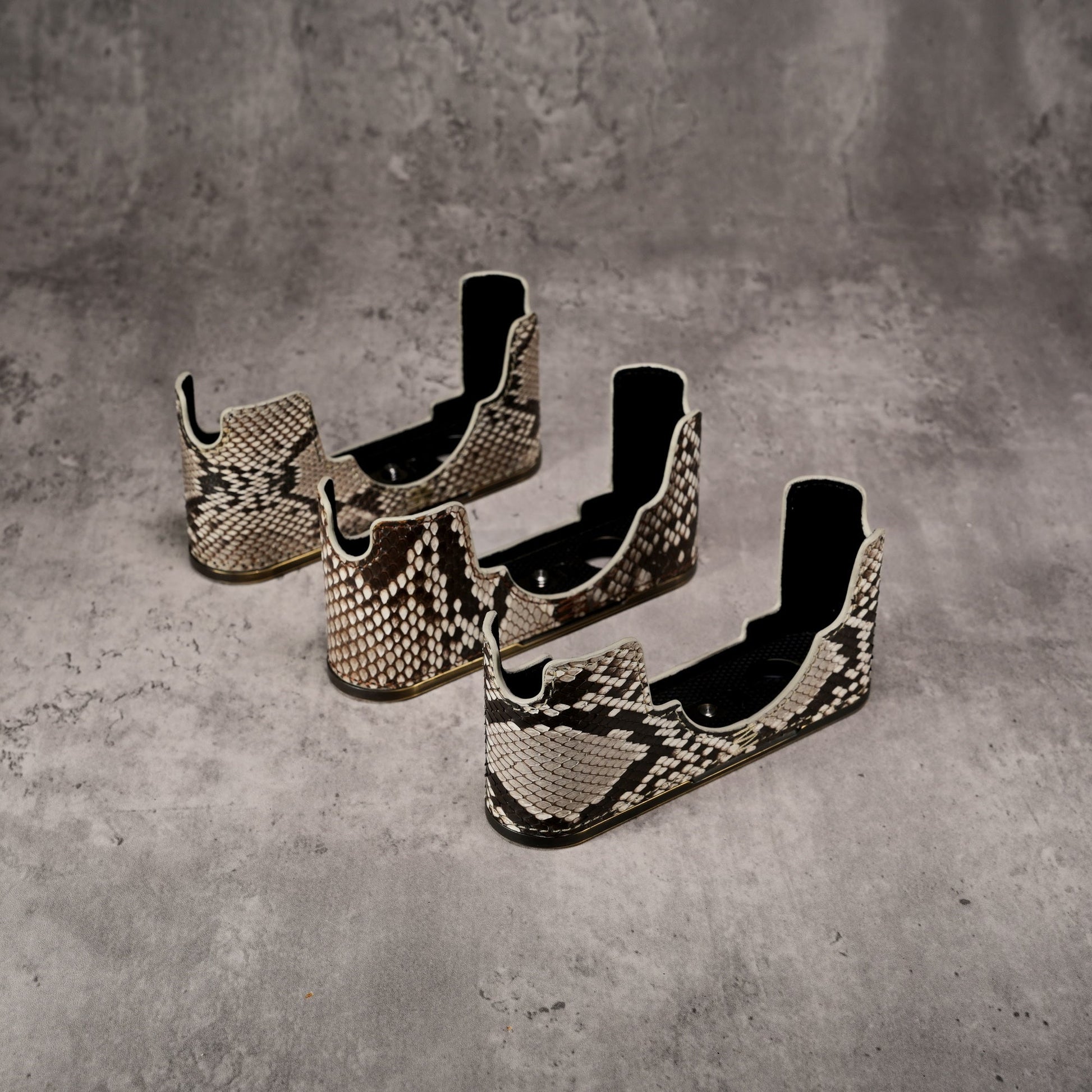 Three Python FlexCase bodies side by side, each with different scale patterning
